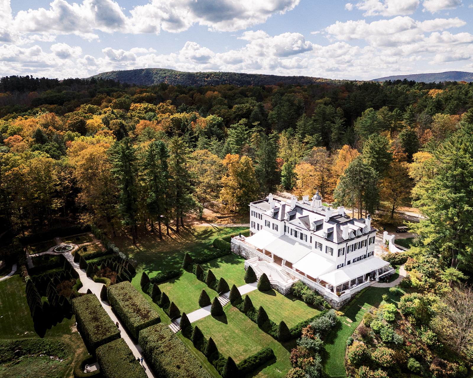Aerial view of The Mount estate and gardens surrounded by peak fall foliage in the Berkshires