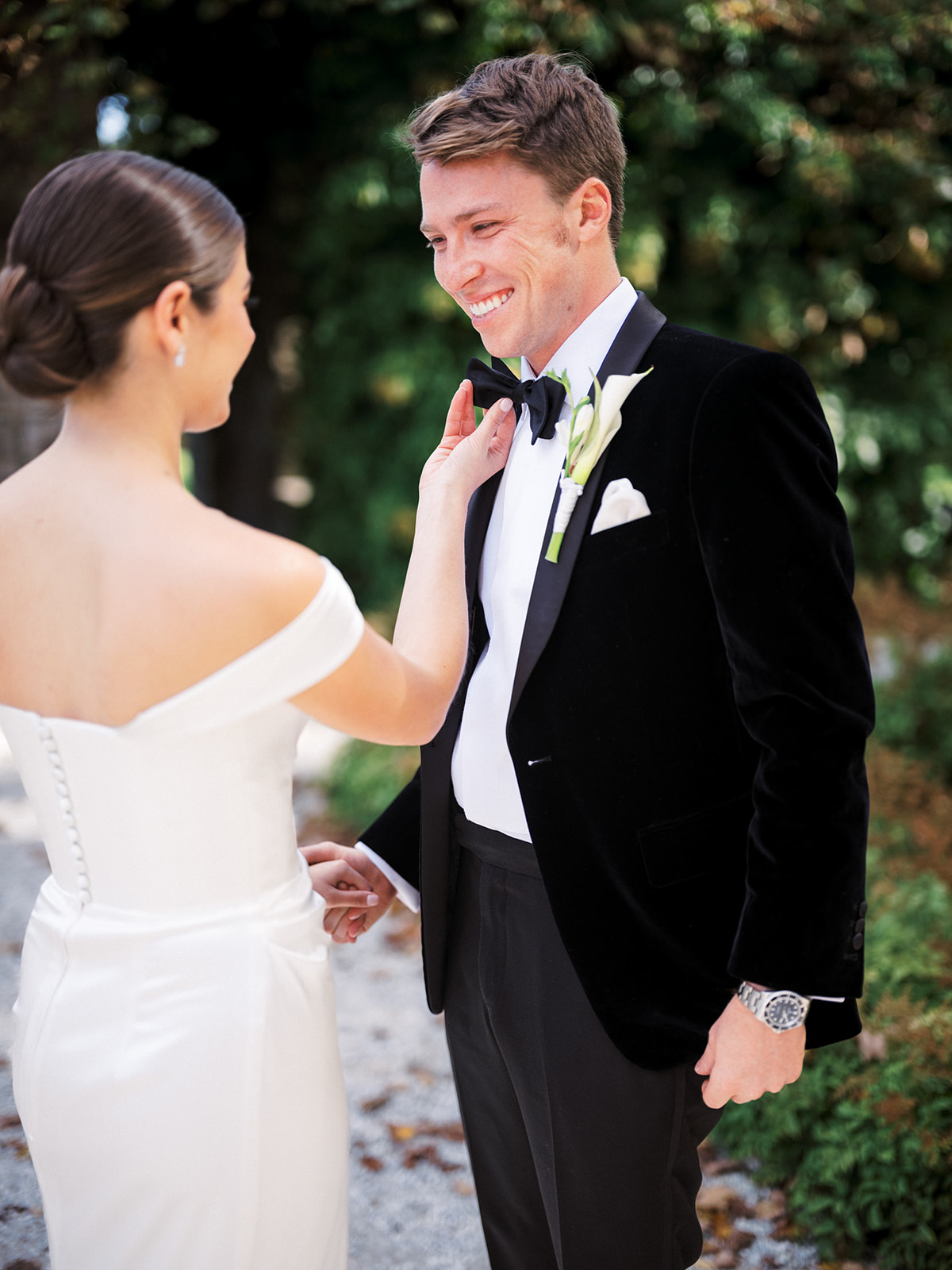 Bride adjusting groom’s bowtie during first look in the garden at The Mount, Lenox