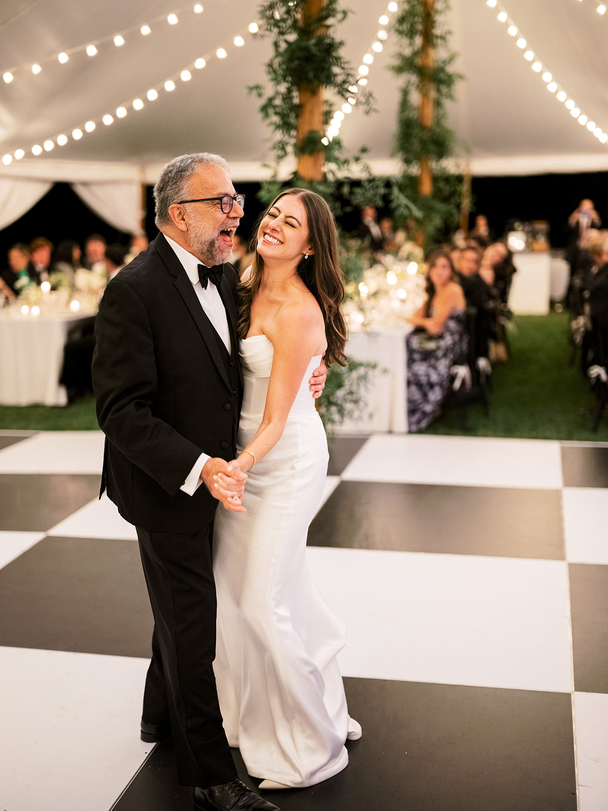 Bride and father dance together.