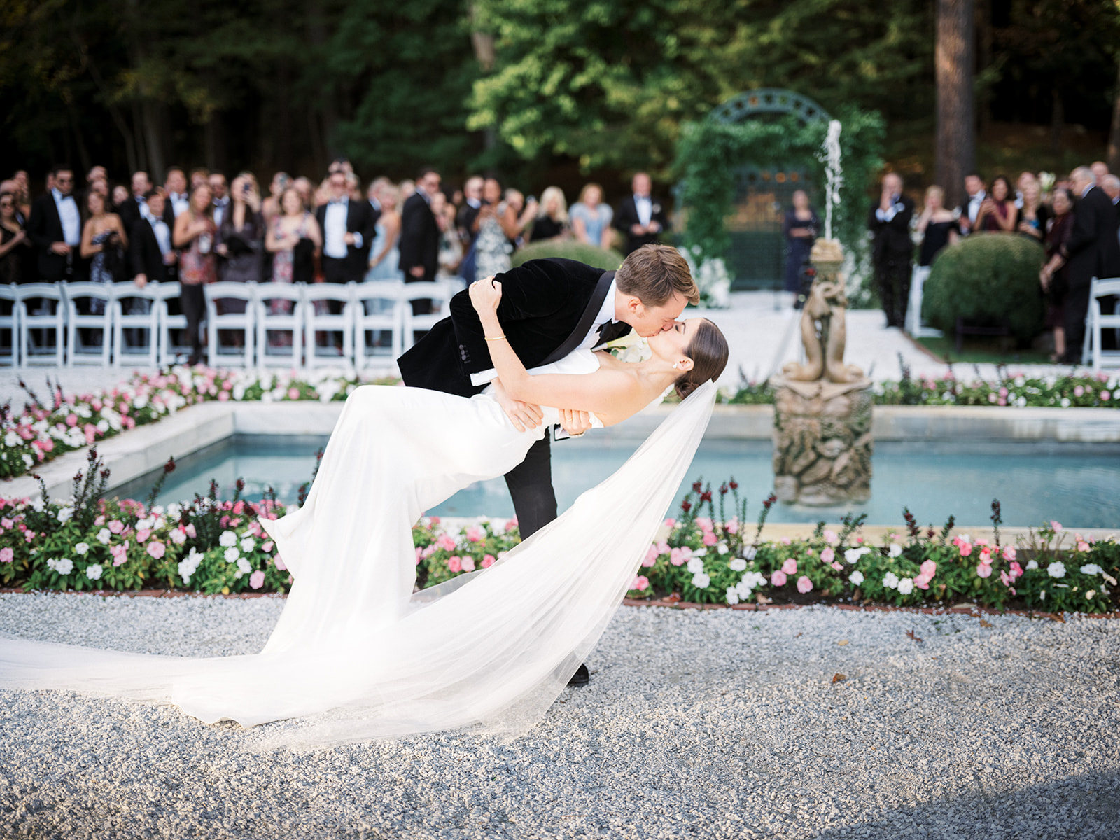 Bride and groom kiss walking down the aisle.