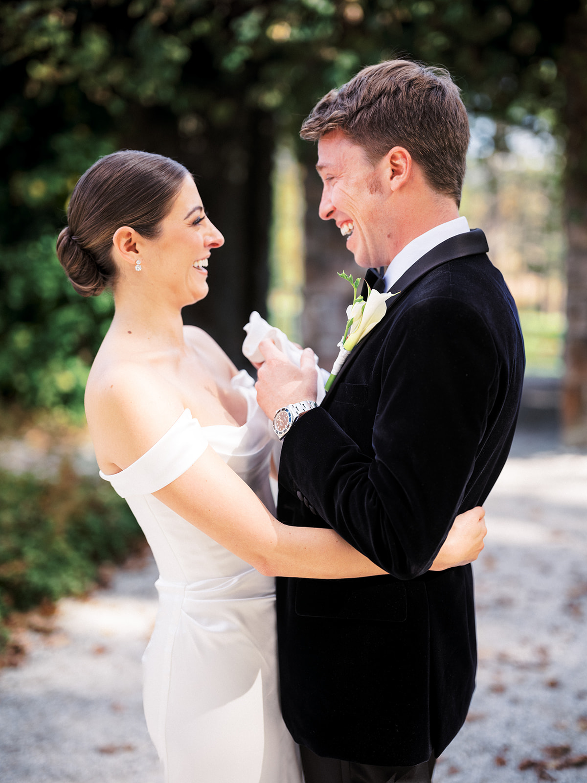 Bride and groom laughing during emotional first look moment before wedding ceremony