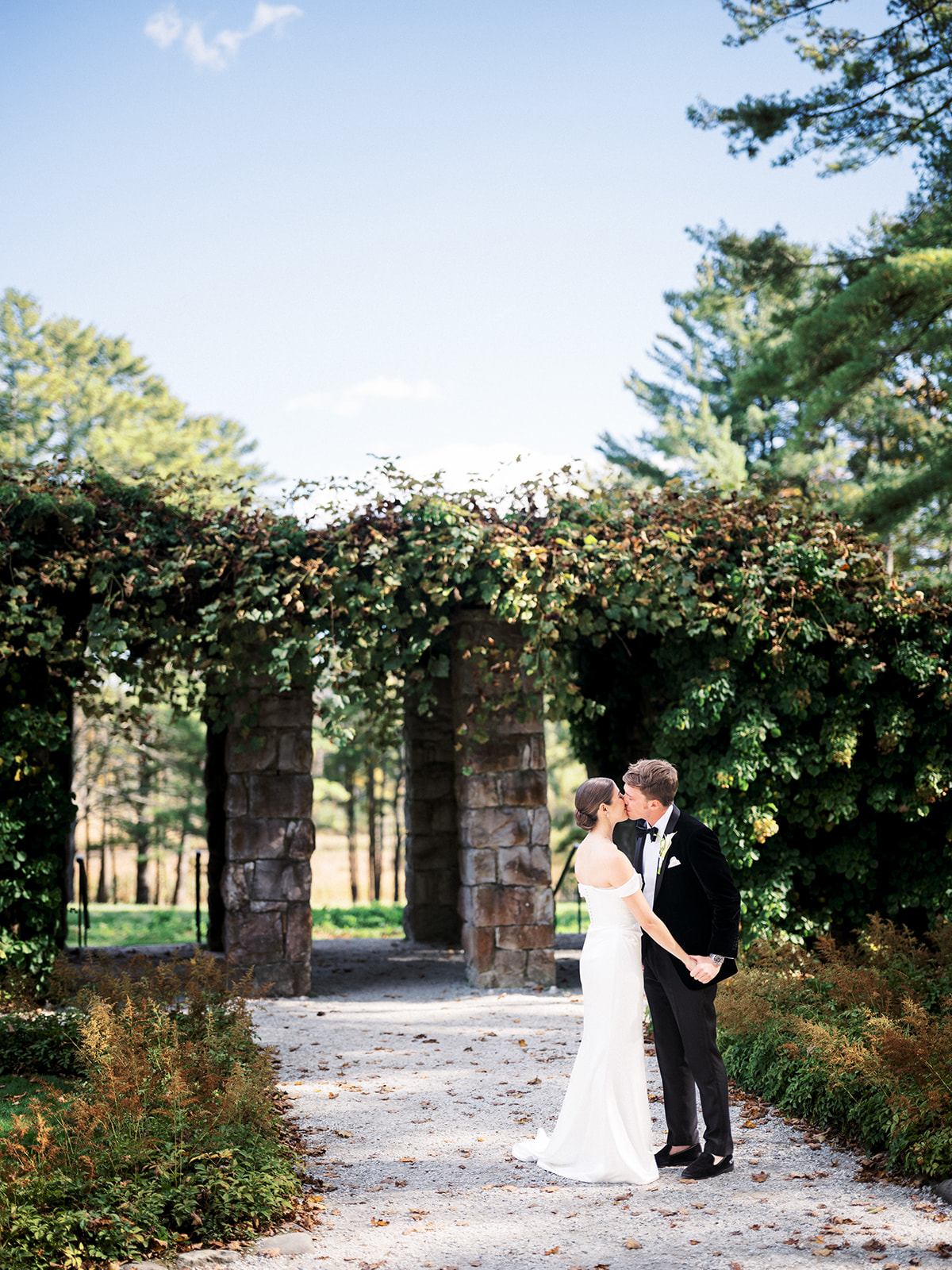 Bride and groom share a kiss in the garden.