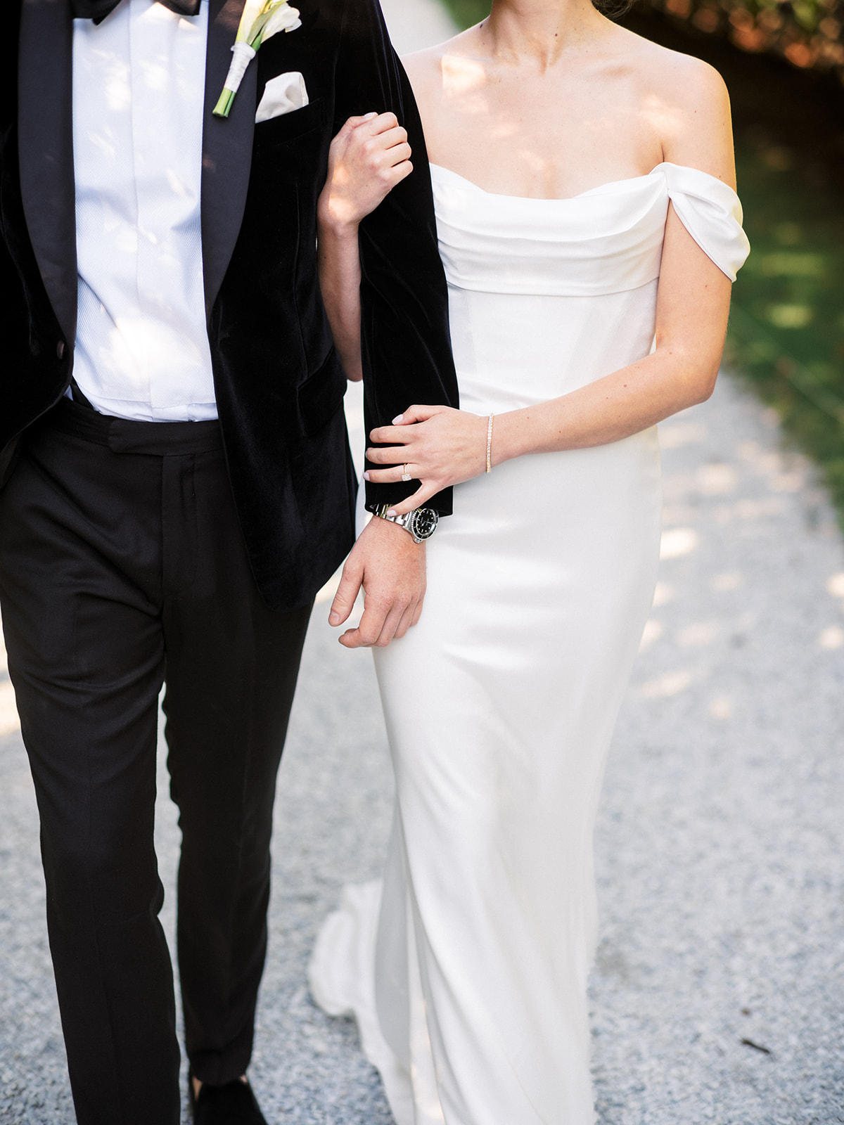 Bride and groom walking in the garden area.