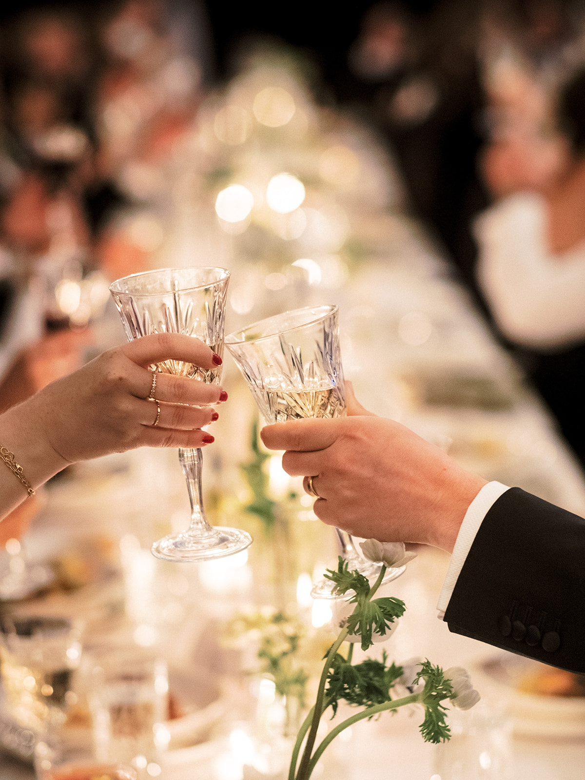 A couple toasts to the bride and groom.