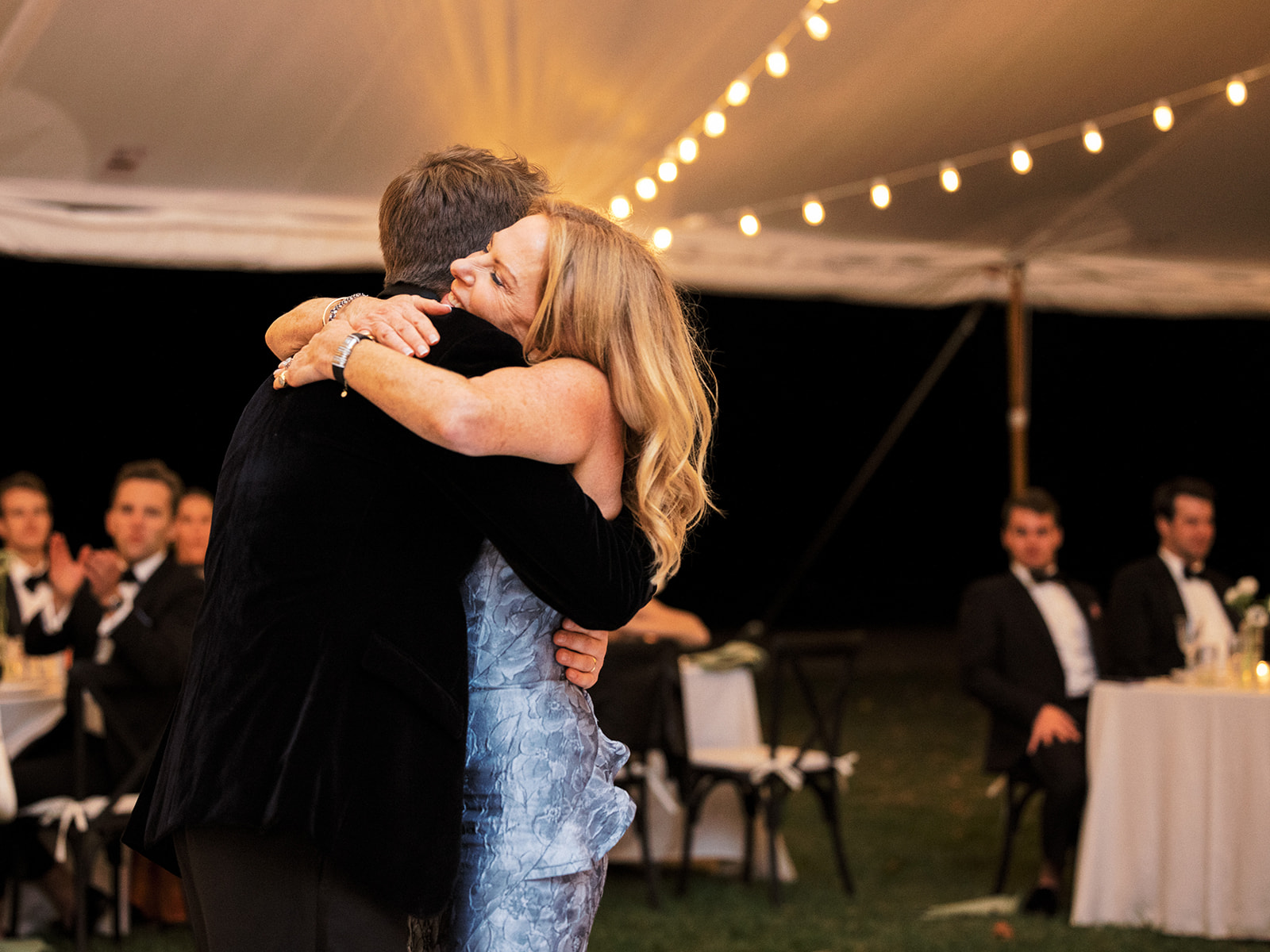 Groom hugs his mother during parent dances.