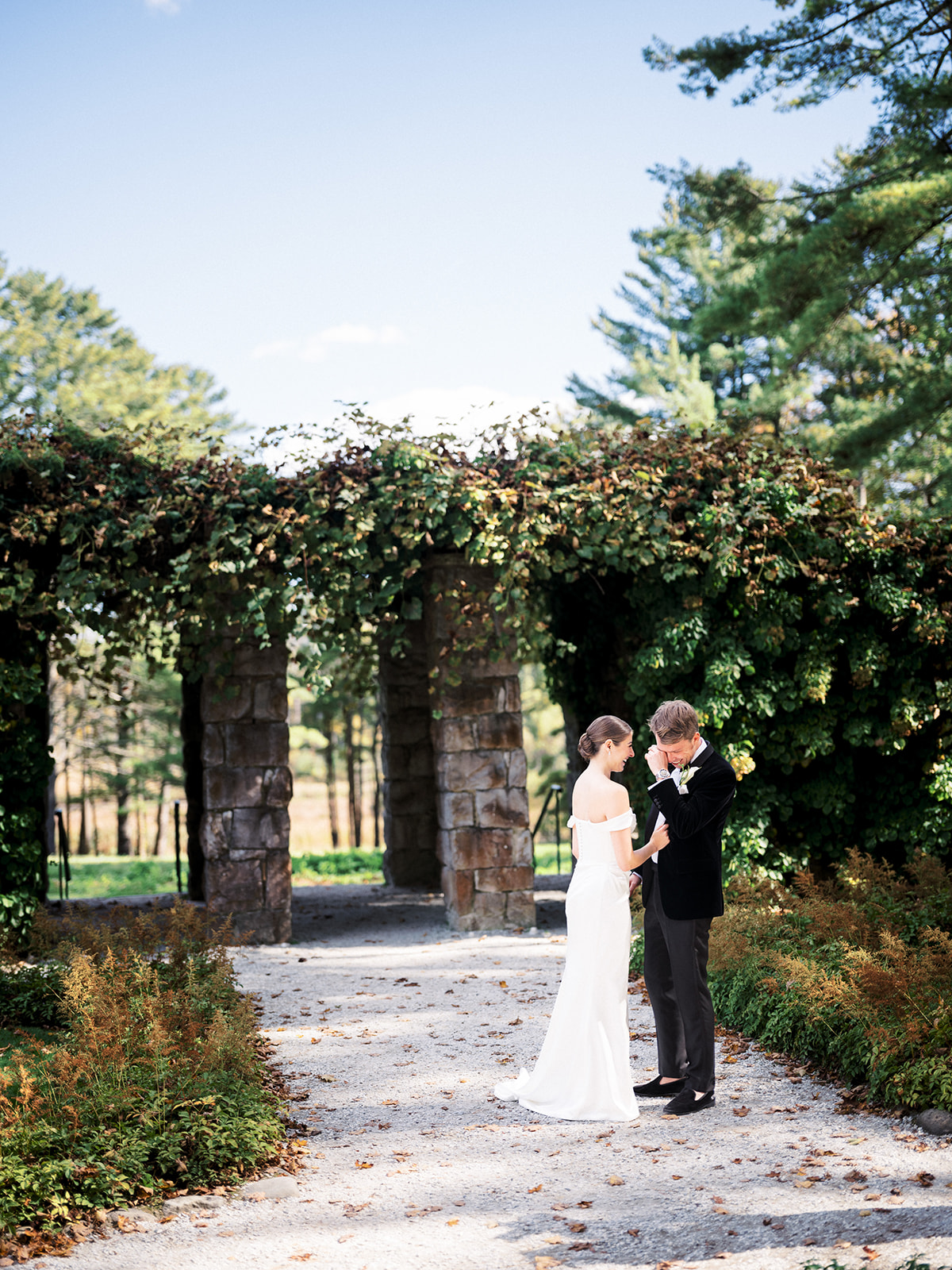 Groom wiping away tears as bride holds his hand during intimate first look at The Mount