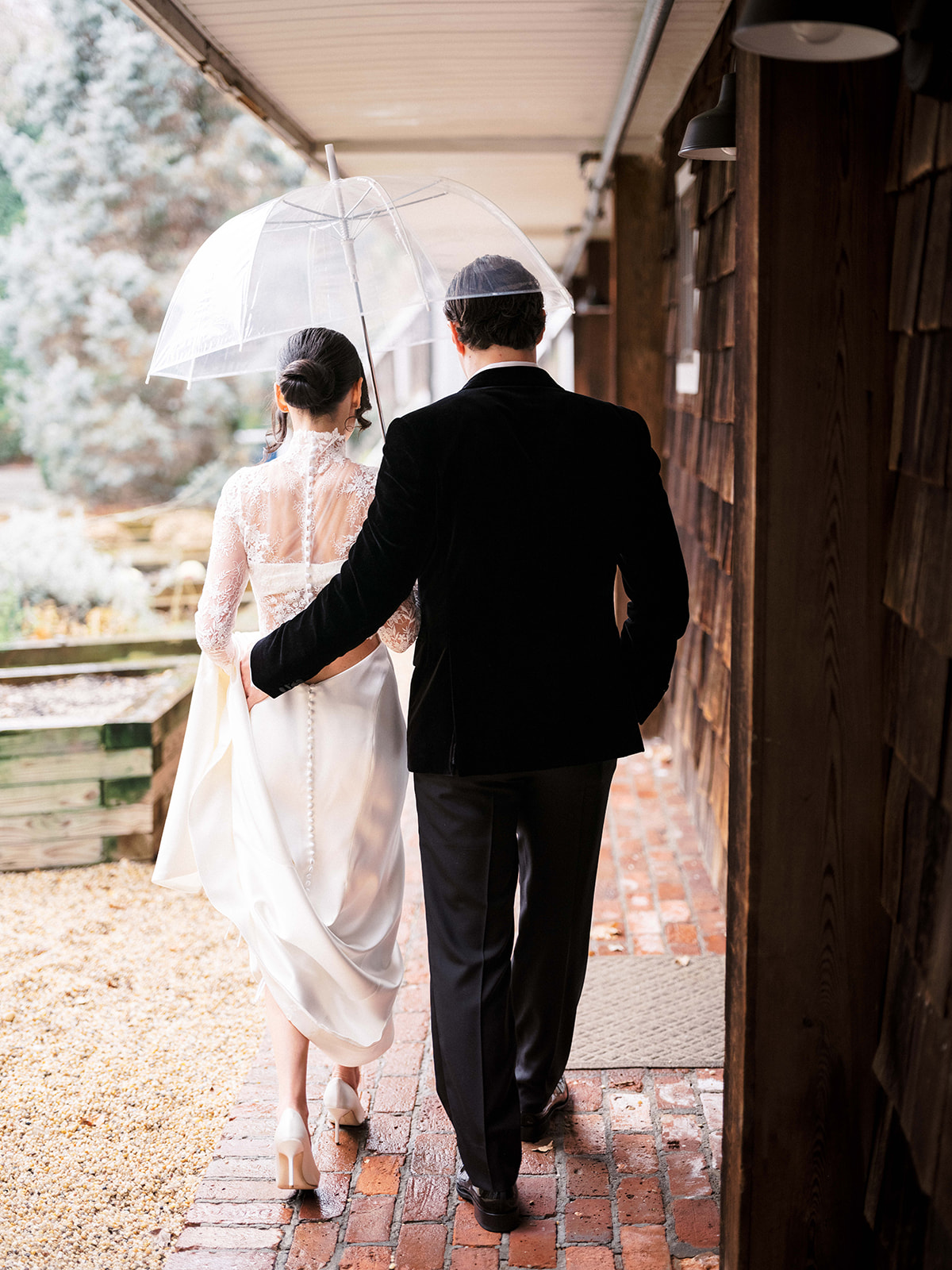 Black and white photo of bride embracing the groom in natural light.