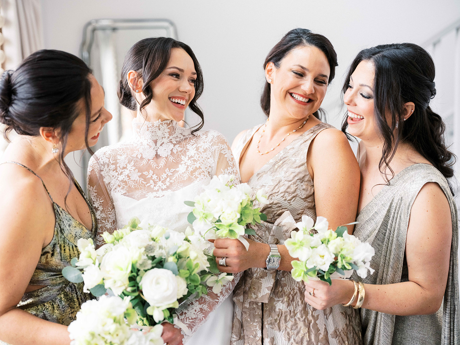 Bridal party sharing a candid moment before heading to the first look at Baron's Cove.