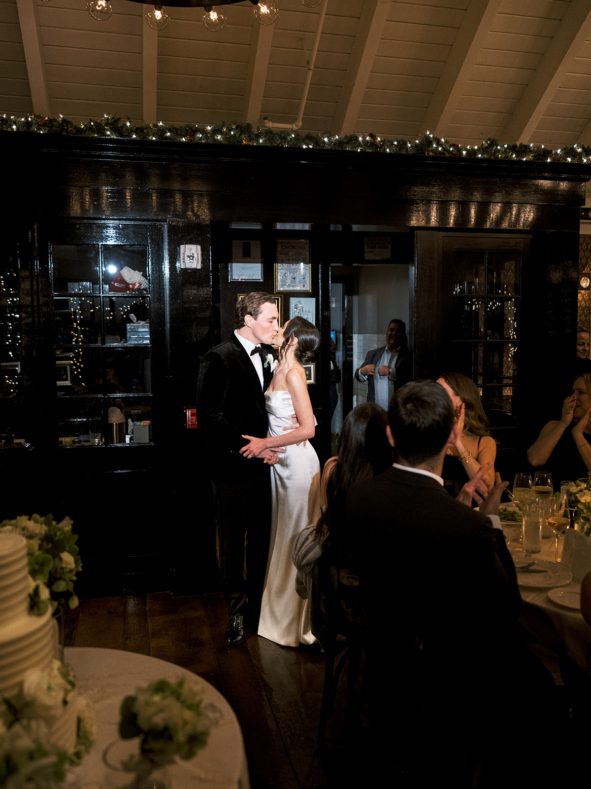 Bride and groom being introduced to the reception by cheering guests.