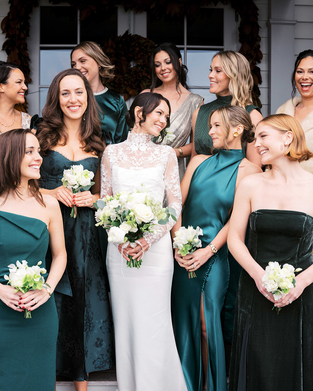 Bride smiling with her bridesmaids outside on the lawn at Baron's Cove.