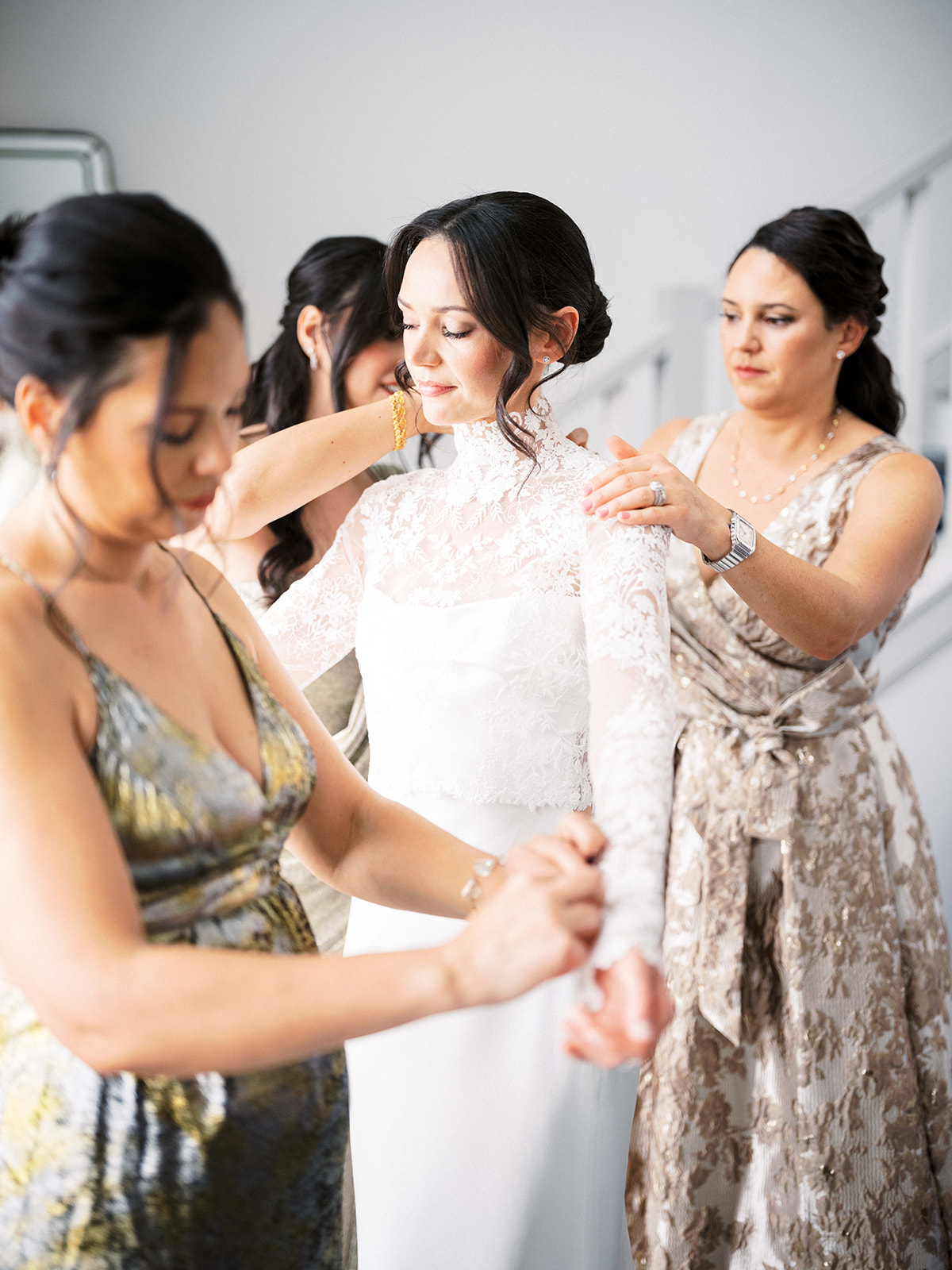 Bridesmaids helping the bride with final touches before the ceremony.