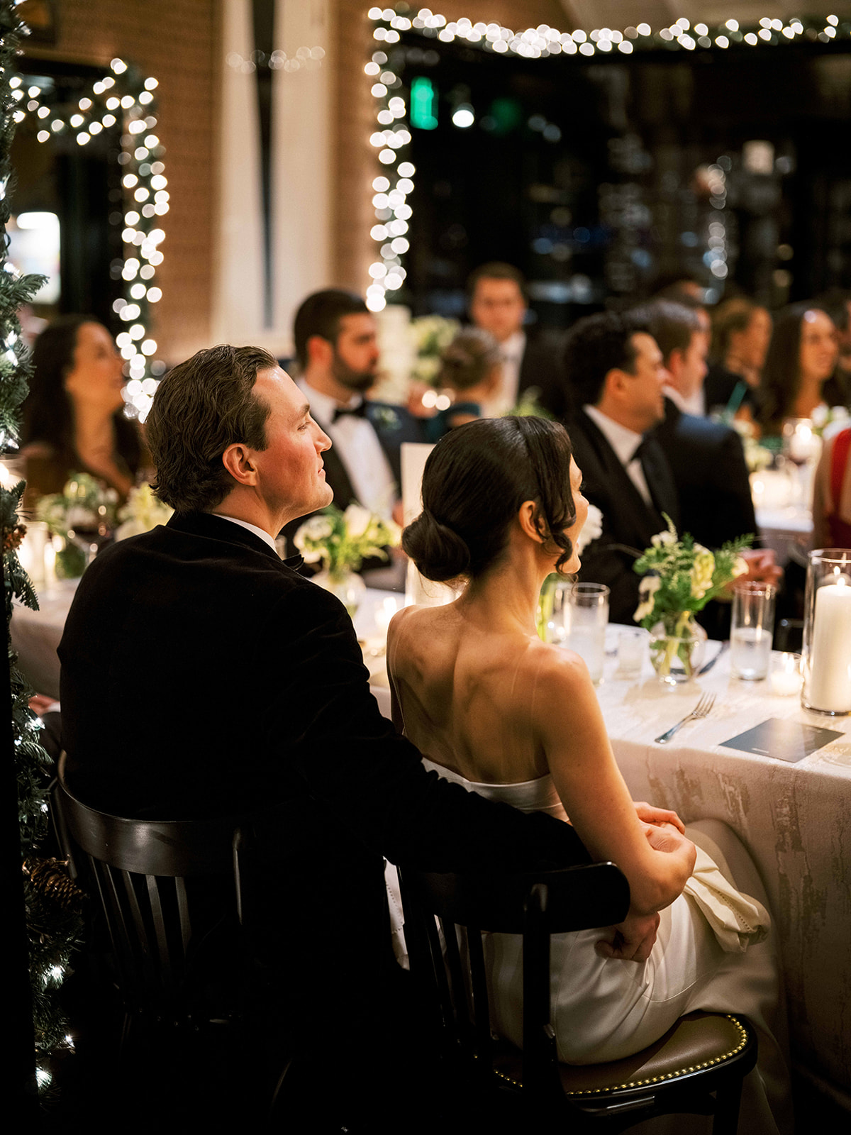 Candid moment of bride laughing while seated at the head table.