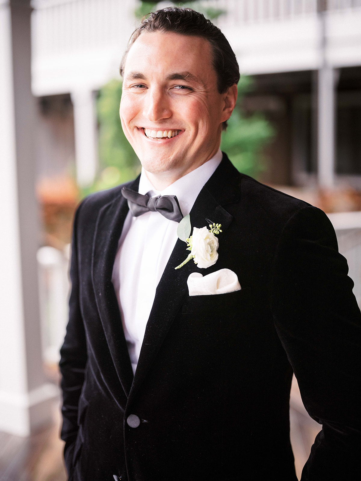 Close-up of groom smiling at the bride with joy during their first look.
