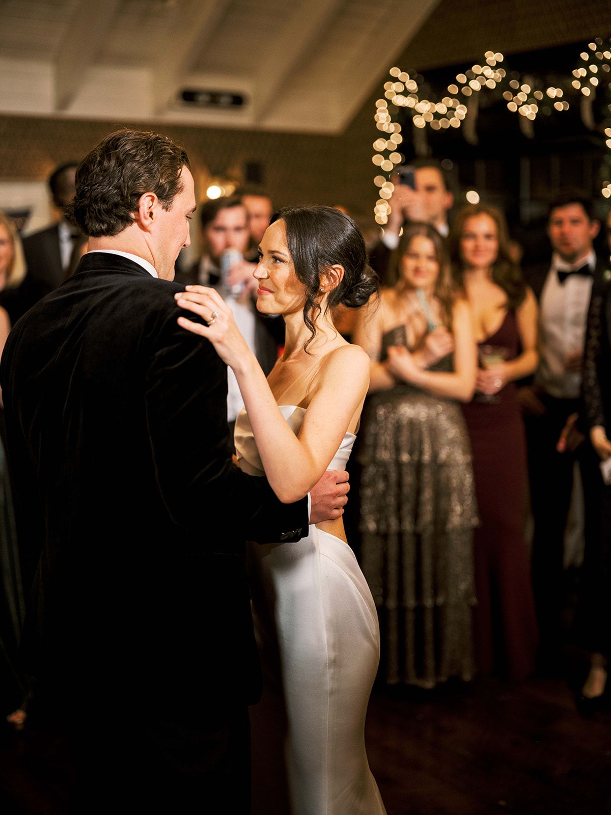 Couple sharing a kiss during their first dance on the reception floor.