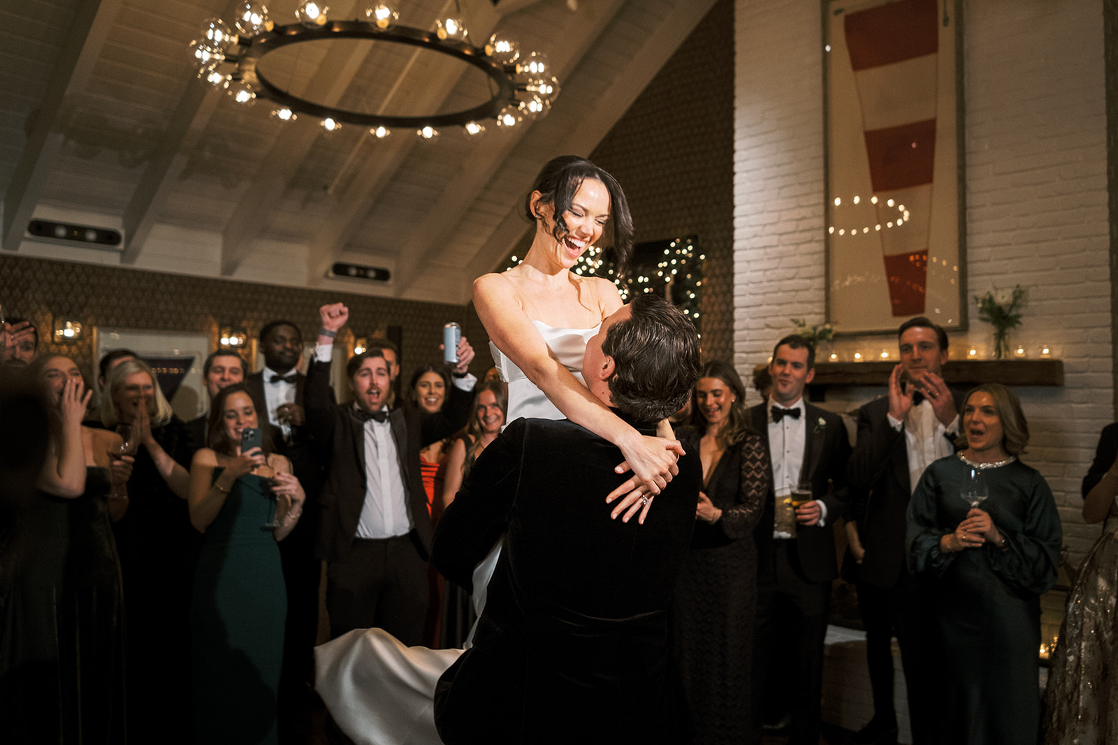 Elegant reception space lit with warm uplighting and chandeliers.