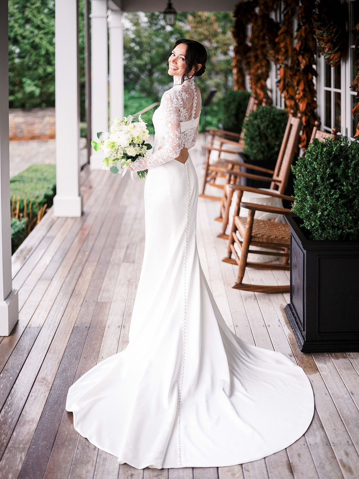 Full-length portrait of the bride outdoors on the steps at Baron's Cove.