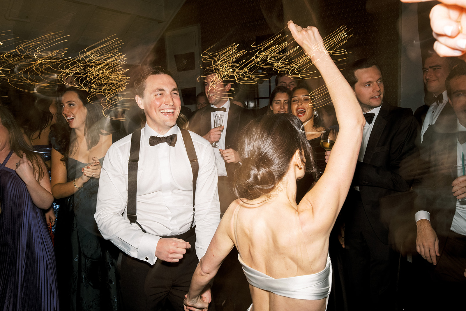Groom celebrating with guests as the reception party picks up energy.