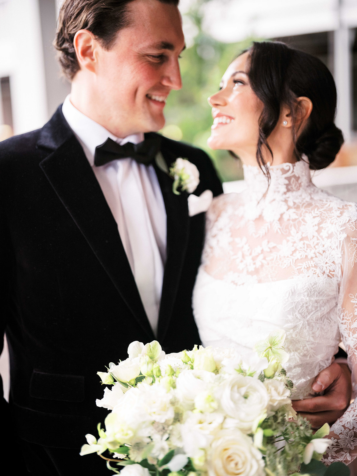 Groom holding the bride close during an emotional first look moment.