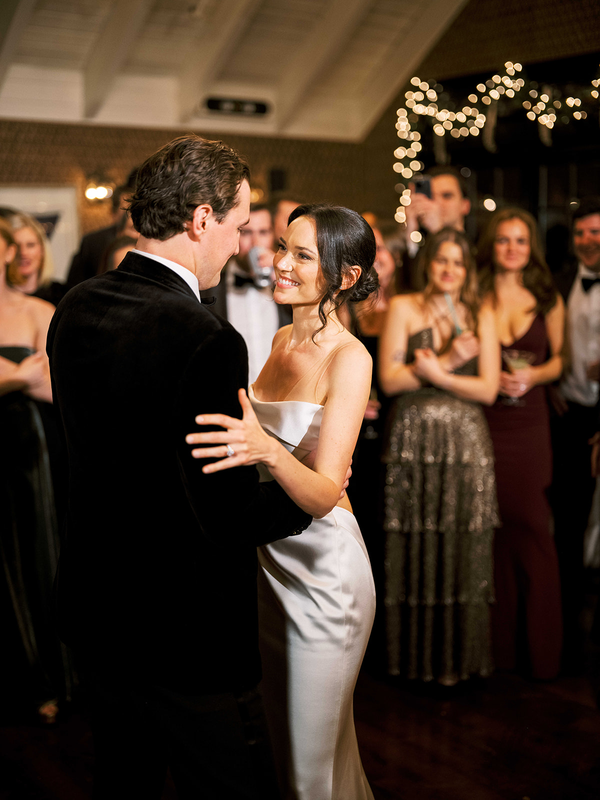 Groom lifting the bride into a spin during an energetic dance moment.
