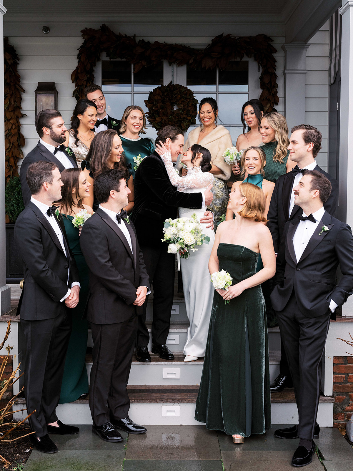 Mixed group of friends posing for joyful wedding party photo.