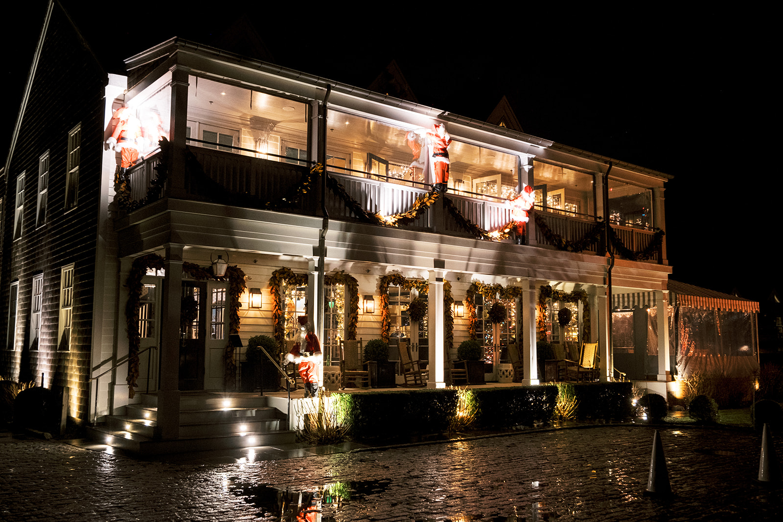 Nighttime exterior view of Baron's Cove warmly lit after dark.