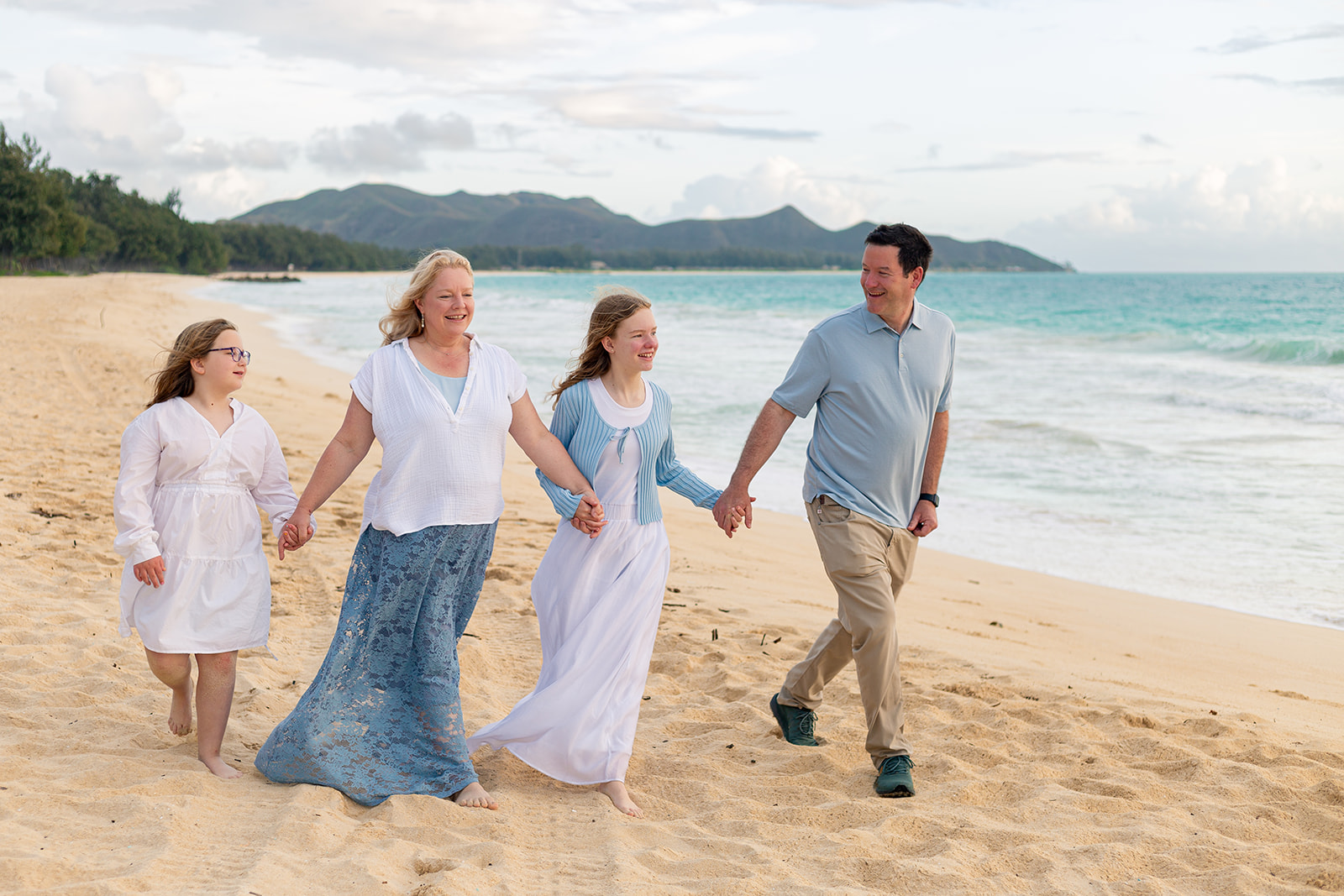 Family beach portraits at Sherwoods Waimanalo with Ironwood trees and white sand.