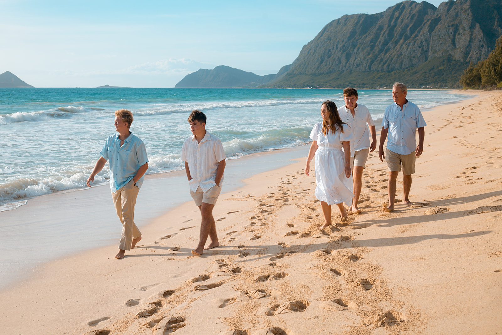 Family beach portraits at Sherwoods Waimanalo with Ironwood trees and white sand.