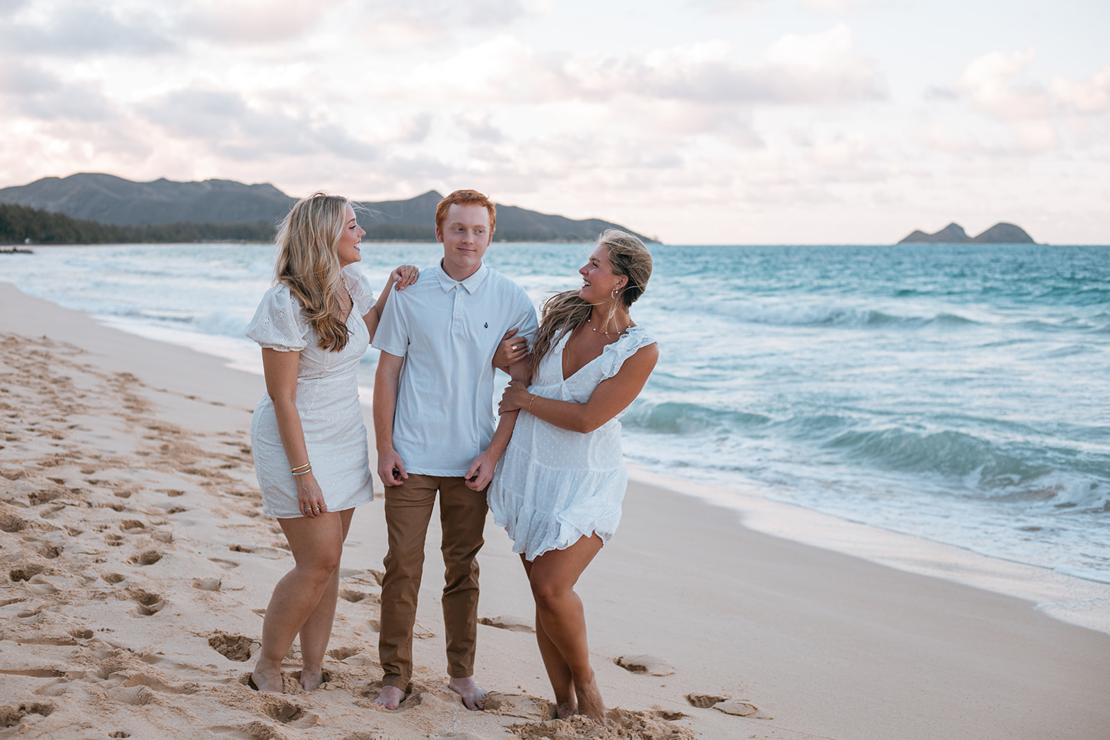Family beach portraits at Sherwoods Waimanalo with Ironwood trees and white sand.