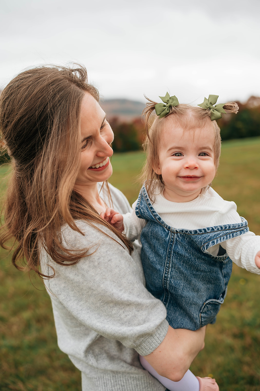 Mom and her giggling baby girl in a flower crown during a fall session in Stowe